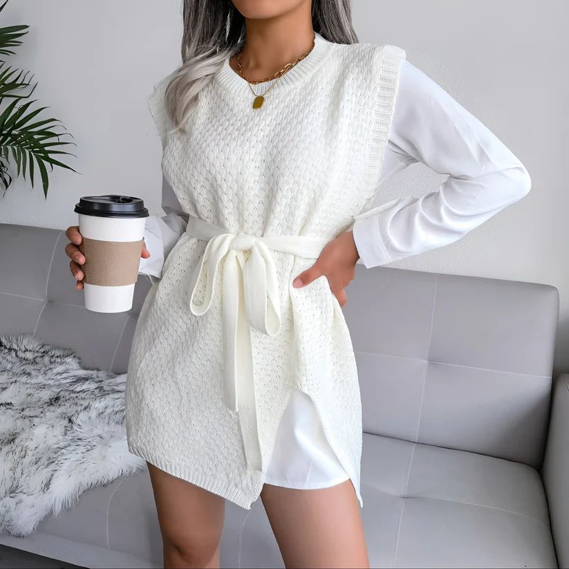 a woman in a white dress holding a cup of coffee