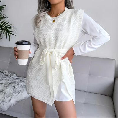 a woman in a white dress holding a cup of coffee