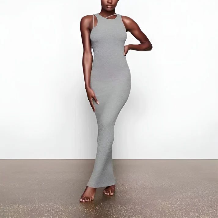 a woman in a gray dress posing for a picture