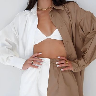 a woman wearing a white shirt and tan pants