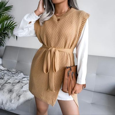 a woman wearing a tan dress and a white shirt