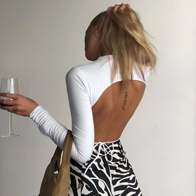 a woman holding a wine glass in her right hand