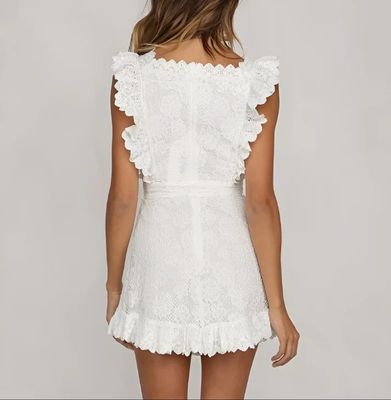 a woman wearing a white dress with ruffles