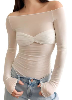 a woman wearing a white top and jeans