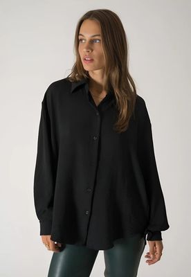 a woman wearing a black shirt and green leggings