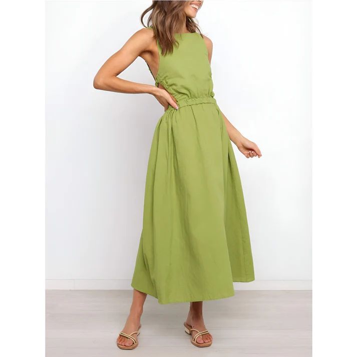 a woman wearing a green dress and sandals