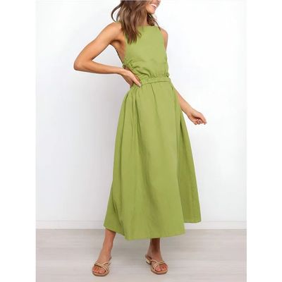 a woman wearing a green dress and sandals