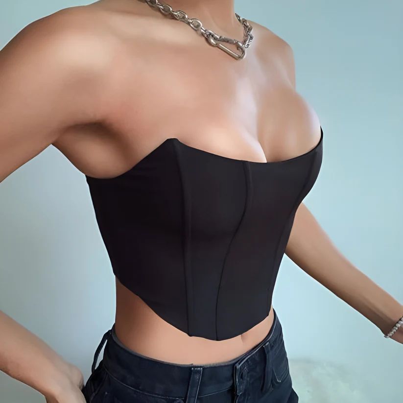 a woman wearing a black top with a chain around her neck