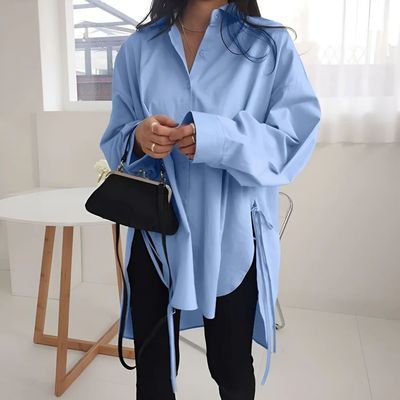 a woman wearing a blue shirt and black pants