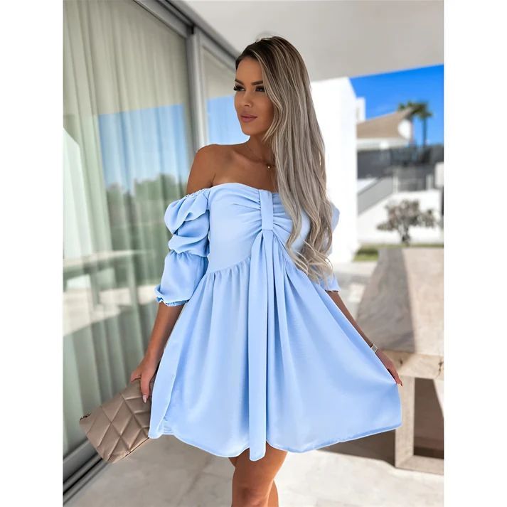 a woman wearing a light blue dress