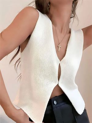 a woman wearing a white top with a cross on it
