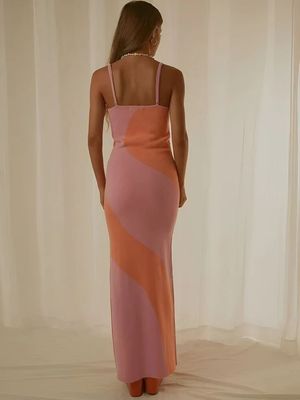a woman in a pink and orange dress