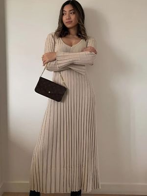 a woman standing in a room with her arms crossed