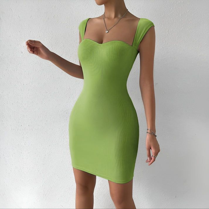 a woman in a green dress posing for a picture
