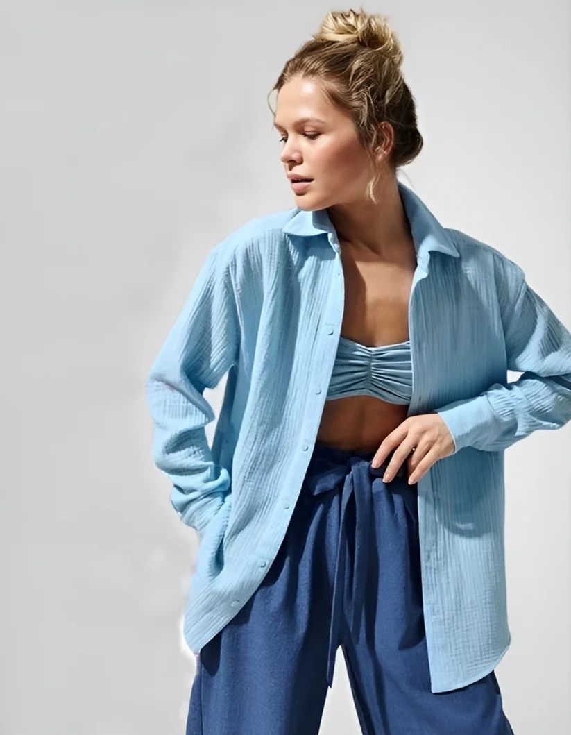 a woman wearing a blue shirt and blue pants
