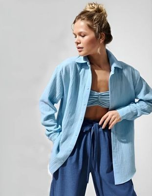 a woman wearing a blue shirt and blue pants