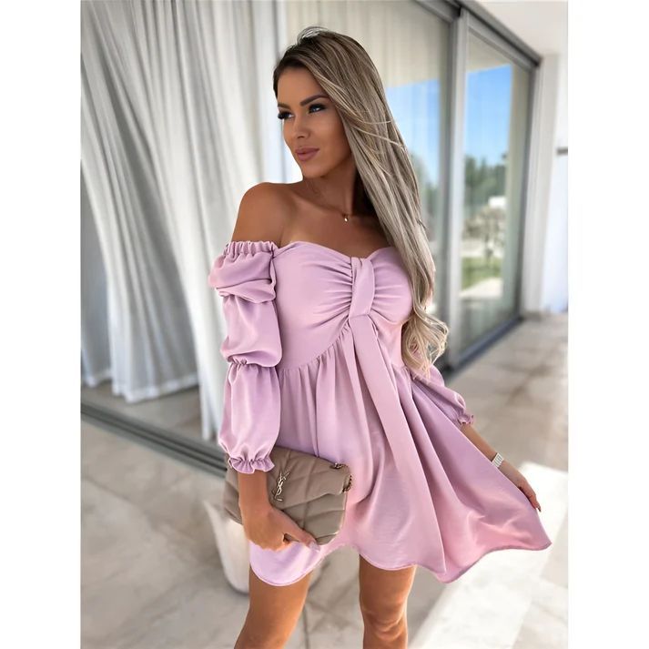 a woman in a pink dress posing for a picture