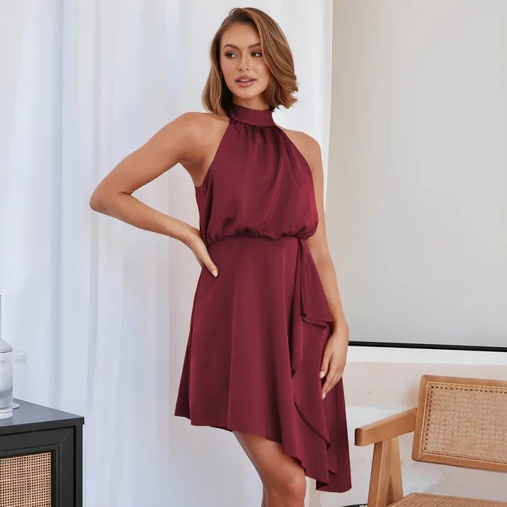 a woman in a maroon dress posing for a picture