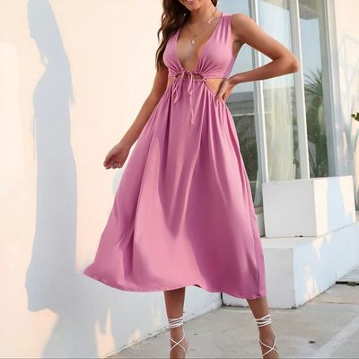 a woman in a pink dress posing for a picture