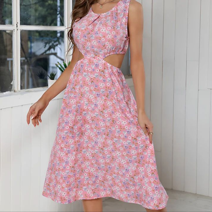 a woman wearing a pink dress with a cut out back