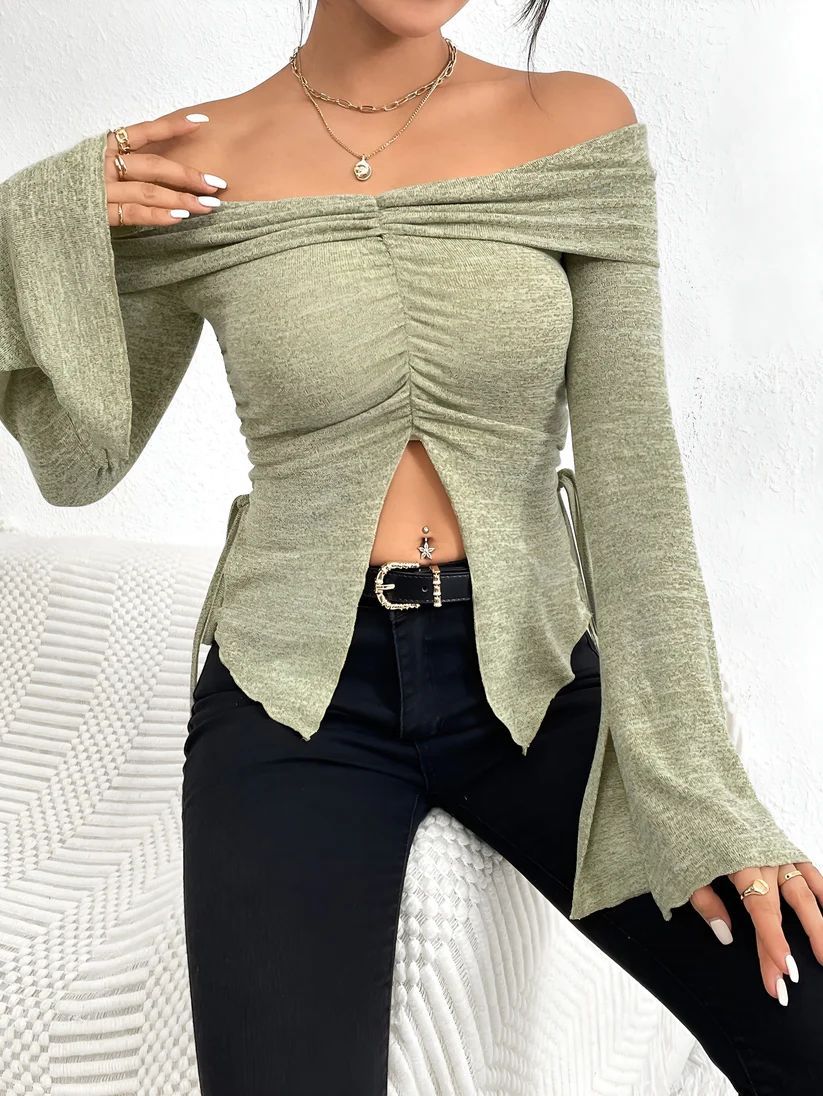 a woman in a green top posing for a picture