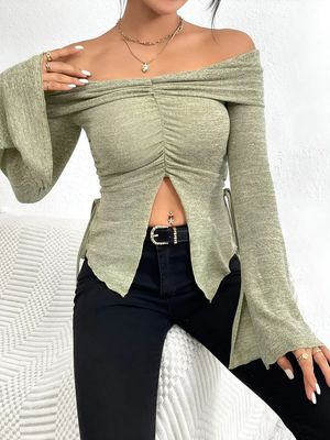 a woman in a green top posing for a picture