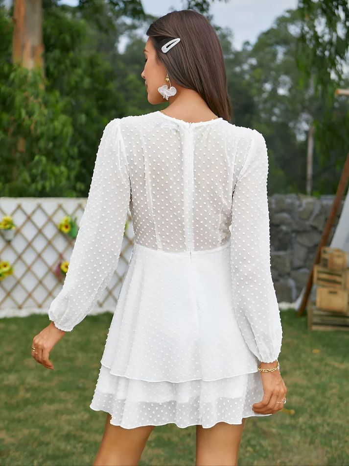 the back of a woman wearing a white dress