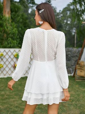 the back of a woman wearing a white dress