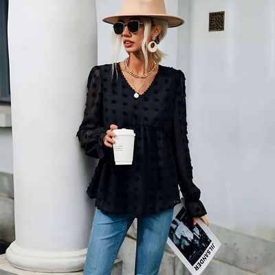 a woman wearing a hat and holding a coffee cup