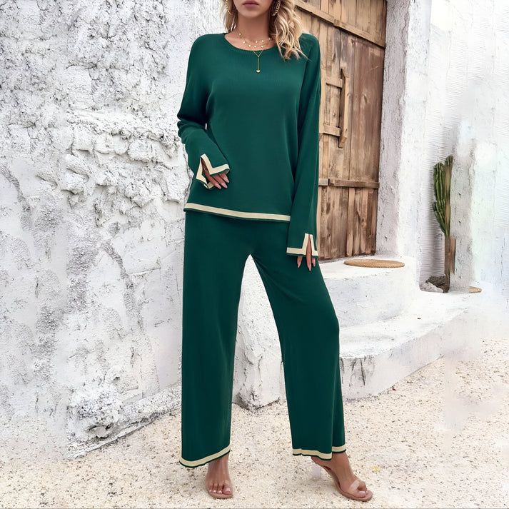 a woman in a green outfit standing in front of a building