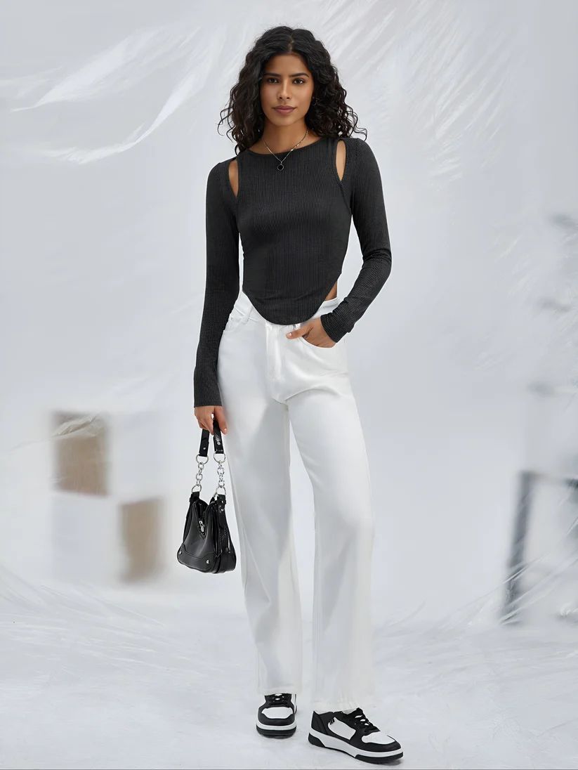 a woman in a black top and white pants