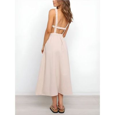 a woman wearing a dress with a cut out back