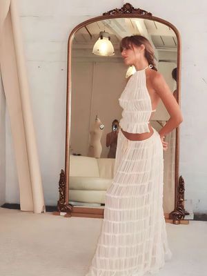 a woman is standing in front of a mirror
