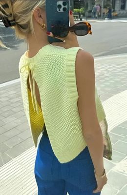 a woman with a cell phone taking a picture of herself