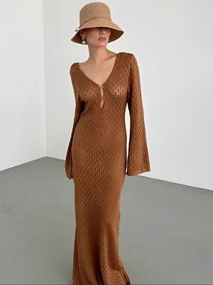 a woman in a brown dress and hat