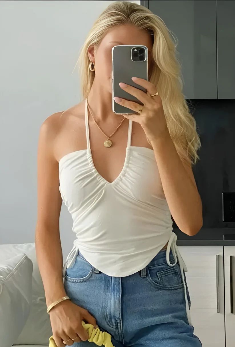 a woman taking a picture of herself in a mirror