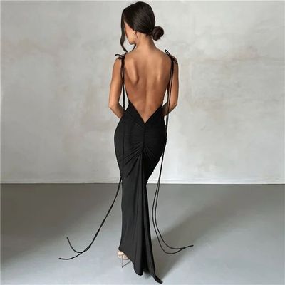 a woman in a black dress with a backless top