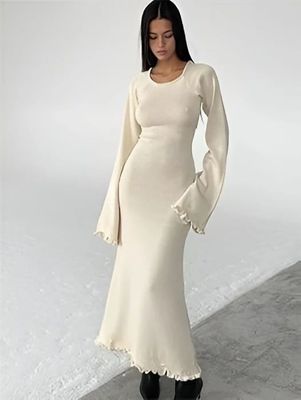 a woman wearing a white dress and black boots