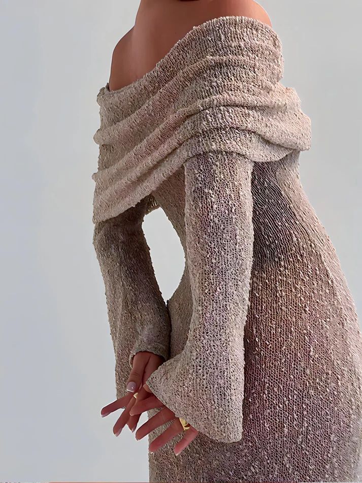 a mannequin wearing a dress with a long sleeve