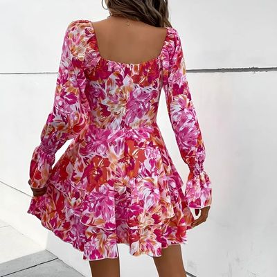 a woman in a pink floral print dress