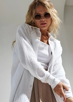 a woman wearing sunglasses and a white shirt