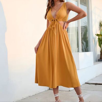 a woman in a yellow dress posing for a picture