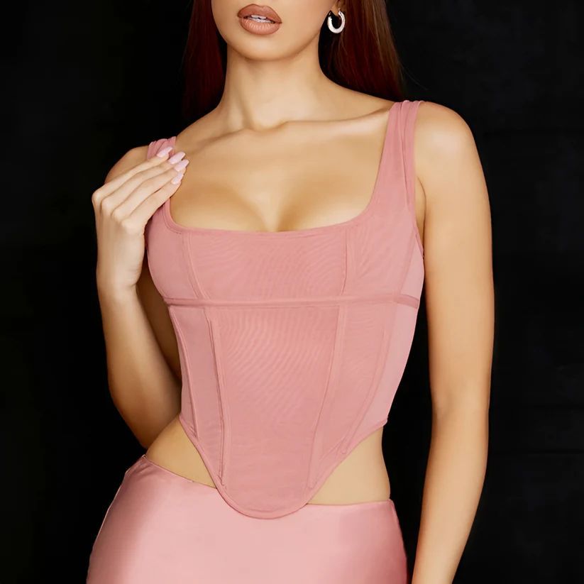 a woman in a pink dress posing for a picture