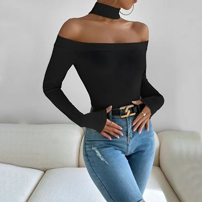 a woman wearing a black top and jeans