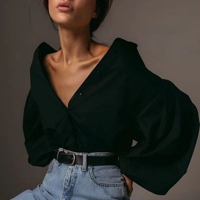 a woman wearing a black shirt and jeans