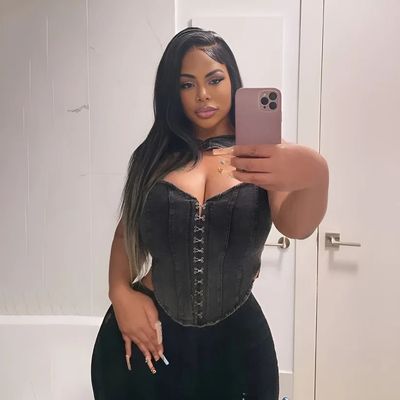 a woman taking a selfie in a corset