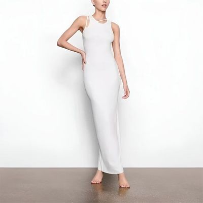 a woman in a white dress posing for a picture