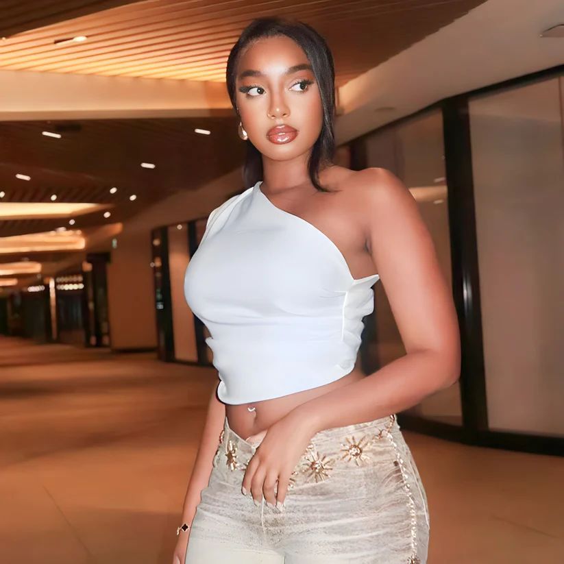 a woman in a white top posing for a picture