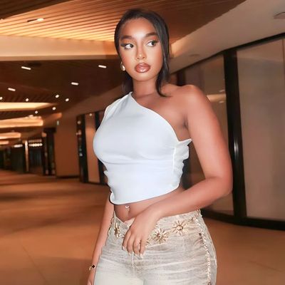 a woman in a white top posing for a picture
