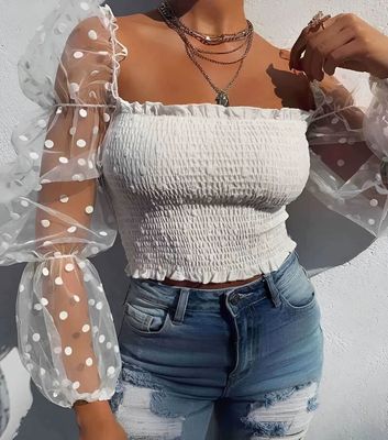 a woman wearing a white top and jeans